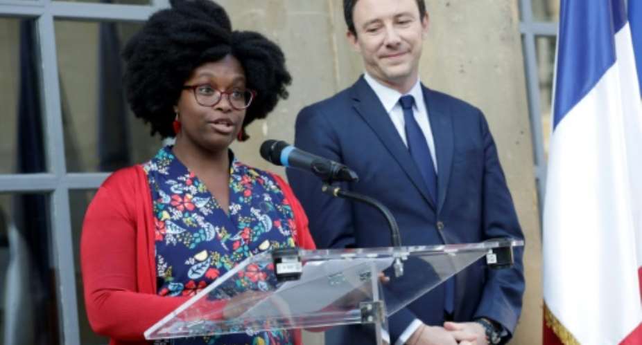 Newly appointed French government spokesperson Sibeth Ndiaye, left, and her predecessor Benjamin Griveaux at a handover ceremony in Paris on Monday.  By Thomas SAMSON AFP