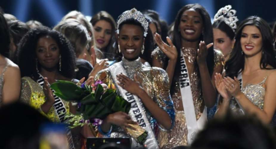 Newly crowned Miss Universe 2019 South Africa's Zozibini Tunzi C poses on stage with contestants after the 2019 Miss Universe pageant at the Tyler Perry Studios in Atlanta, Georgia.  By VALERIE MACON AFP