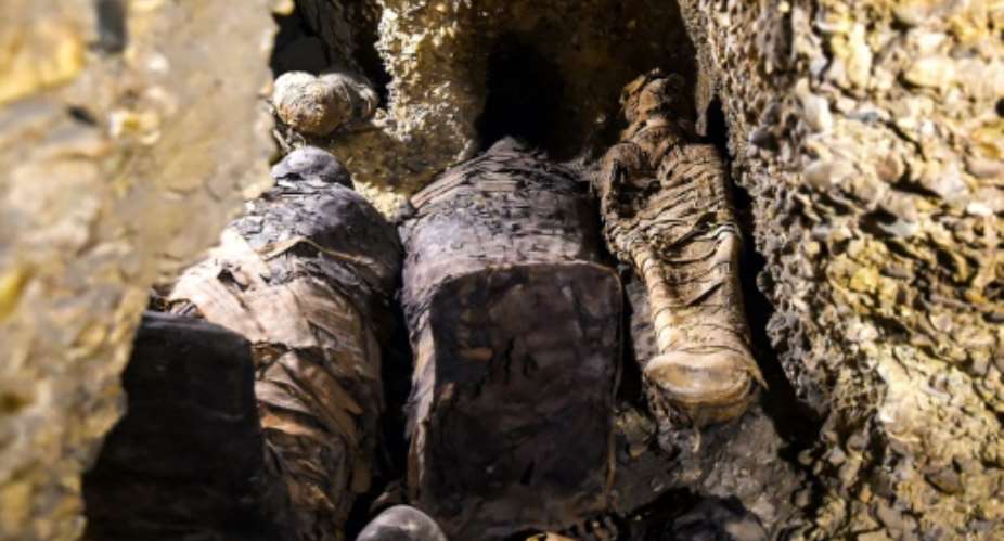 Newly-discovered mummies wrapped in linen found in burial chambers dating to the Ptolemaic era (323-30 BC) at the necropolis of Tunah al-Gabal in Egypt's southern Minya province.  By MOHAMED EL-SHAHED (AFP)