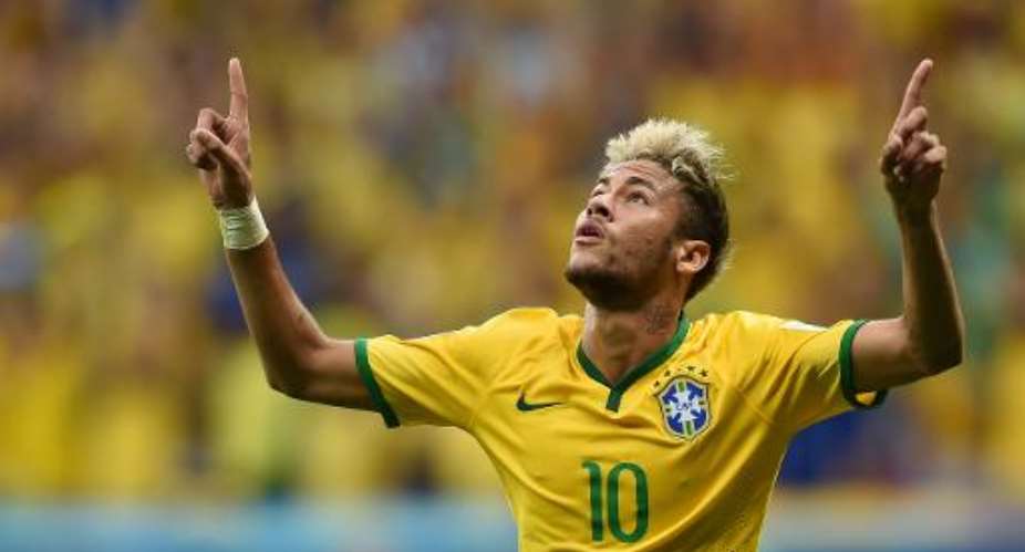 Brazil's forward Neymar celebrates after scoring a second goal during the match between Cameroon and Brazil at the Mane Garrincha National Stadium in Brasilia on June 23, 2014.  By Pedro Ugarte AFP