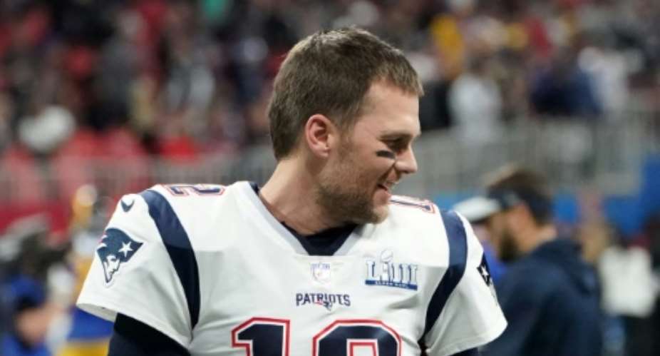 NFL star quarterback Tom Brady shown in his former Patriots shirt was found exercising in a Tampa City park which was closed under coronavirus restrictions.  By TIMOTHY A. CLARY AFPFile