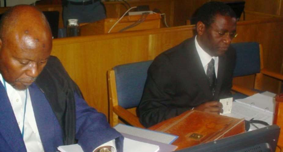 Ngirabatware, right, seated next to his lawyer at the start of his trial in 2008.  By EPHREM RUGURIRIZA AFP