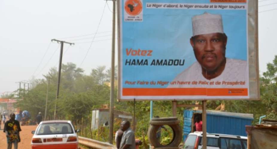 A campaign poster depicting NIger's leading opposition figure and contender in next month's presidential election Hama Amadou, jailed since November 2015 over his alleged involvement in a baby-trafficking scandal.  By Boureima Hama AFP