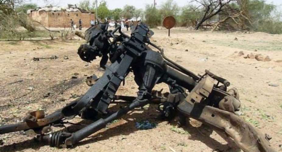 A piece of wreckage from the suicide bombers motor vehicle lies at the army base in northern Niger on May 23, 2013.  By  (AFP/File)