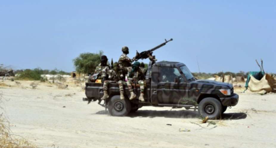 Niger soldiers ride in a military vehicle on May 25, 2015 in Malam Fatori.  By Issouf Sanogo AFPFile