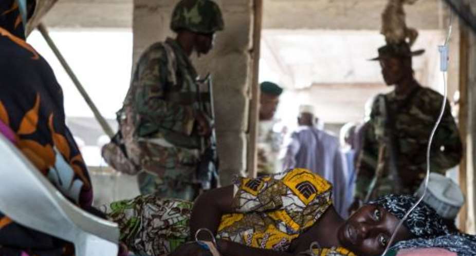 Nigerian soldiers guard a makeshift hospital in Maiduguri on March 25, 2015.  By Nichole Sobecki AFPFile