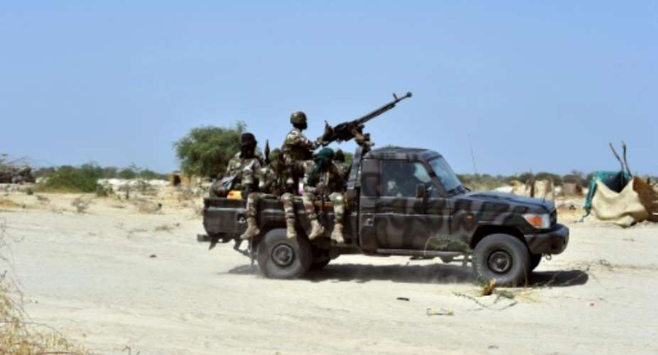 Soldiers ride in a military vehicle on May 25, 2015 in Malam Fatori, in northern Nigeria, where troops are working to fight Boko Haram.  By Issouf Sanogo AFPFile