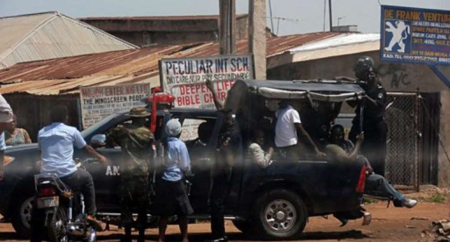 People are escorted out of Kaduna on June 19 after the riots sparked by religious violence.  By Victor Ulasi AFPFile