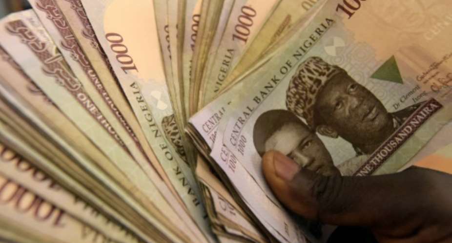 Inflation hit an 11-year high in June after the government freed up the naira currency, allowing it to plummet against the US dollar.  By Pius Utomi Ekpei AFPFile
