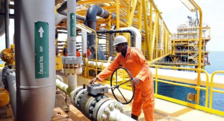 A worker inspecting facilities on an upstream oil drilling platform at the Total oil platform in 2009.  By Pius Utomi Ekpei AFPFile