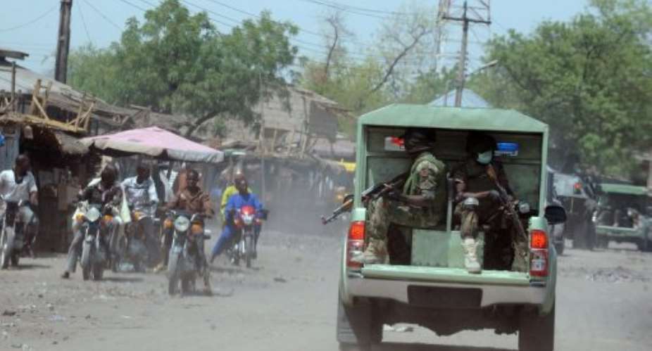 Nigerian troops patrol Maiduguri in Borno State on April 30, 2013.  By Pius Utomi Ekpei (AFP)
