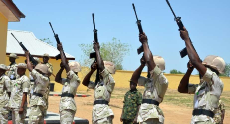 Nigerian soldiers shoot into the air during a ceremony to mark the release of suspected detainees cleared of being members of Boko Haram Islamists in Maiduguri, Borno State on July 6, 2015.  By Stringer (AFP/File)