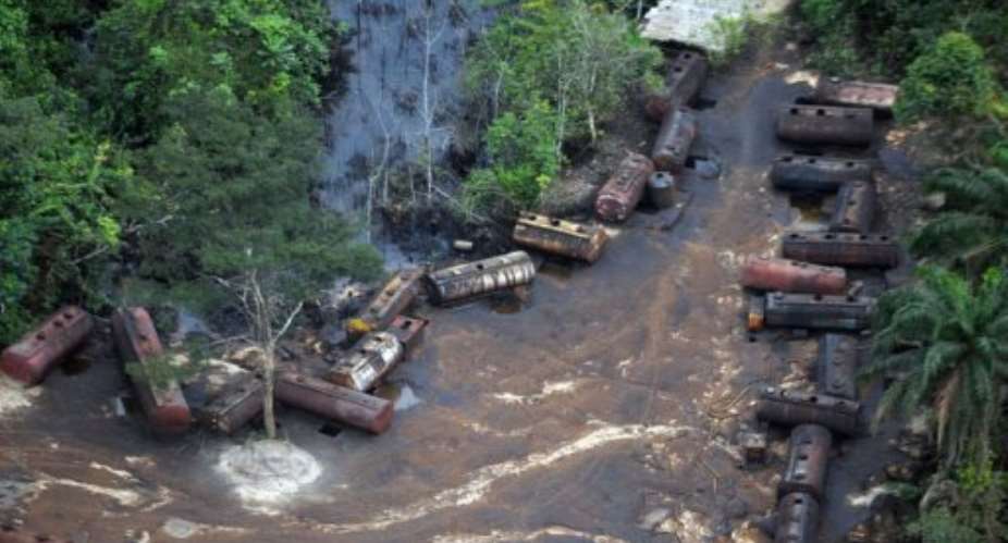 A file picture taken on October 21, 2011 shows Barges laden with stolen oil stationed along the Imo Rivers in Abia state.  By Pius Utomi Ekpei AFPFile