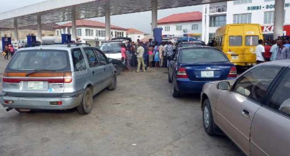 Vehicles queue to buy fuel at a filling station in the Nigerian capital Lagos on March 2, 2014.  By Pius Utomi Ekpei AFPFile