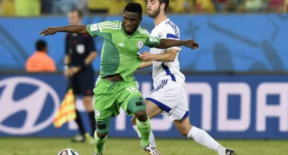 Nigeria forward Michael Babatunde L gets away from Bosnia-Hercegovina midfielder Miralem Pjanic during the World Cup Group F match at the Pantanal Arena in Cuiaba on June 21, 2014.  By Juan Barreto AFP