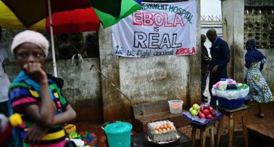A sign warns of the dangers of Ebola outside a government hospital in Freetown on August 13, 2014.  By Carl de Souza AFPFile