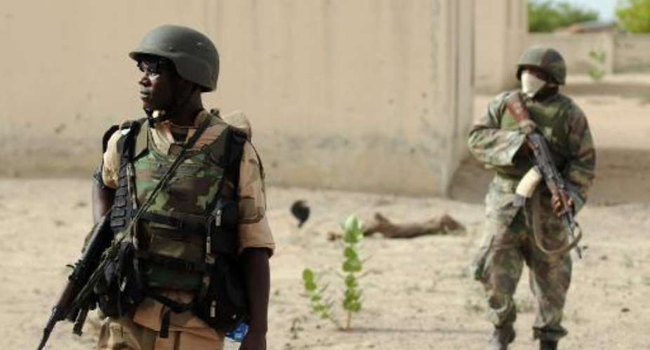 Nigerian soldiers patrol near Maiduguri on June 5, 2013.  By Quentin Leboucher (AFP/File)