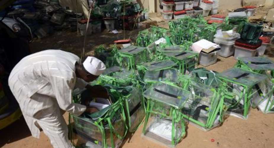 An election official empties ballot boxes in Katsina State on March 29, 2015 following the presidential election.  By Pius Utomi Ekpei AFP