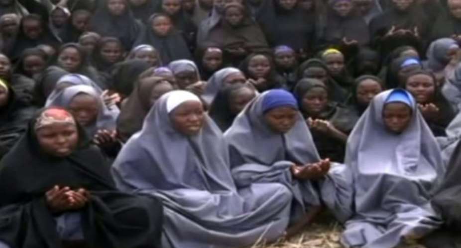 A screengrab taken from a video of Nigerian Islamist extremist group Boko Haram obtained by AFP showing girls, wearing the full-length hijab and praying in an undisclosed rural locationon May 12, 2014.  By HO BOKO HARAMAFPFile