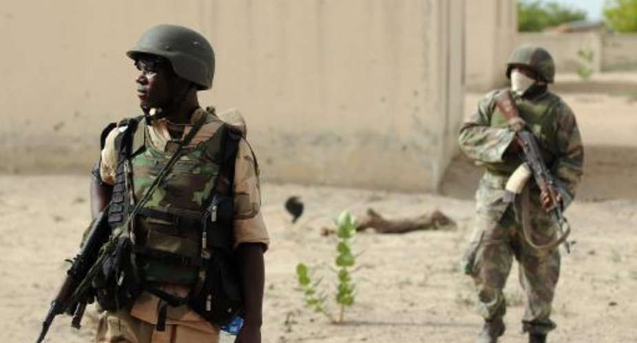 Nigerian soldiers patrol in the north of Borno state close to Islamist extremist group Boko Haram's former camp near Maiduguri on June 5, 2013.  By Quentin Leboucher AFPFile