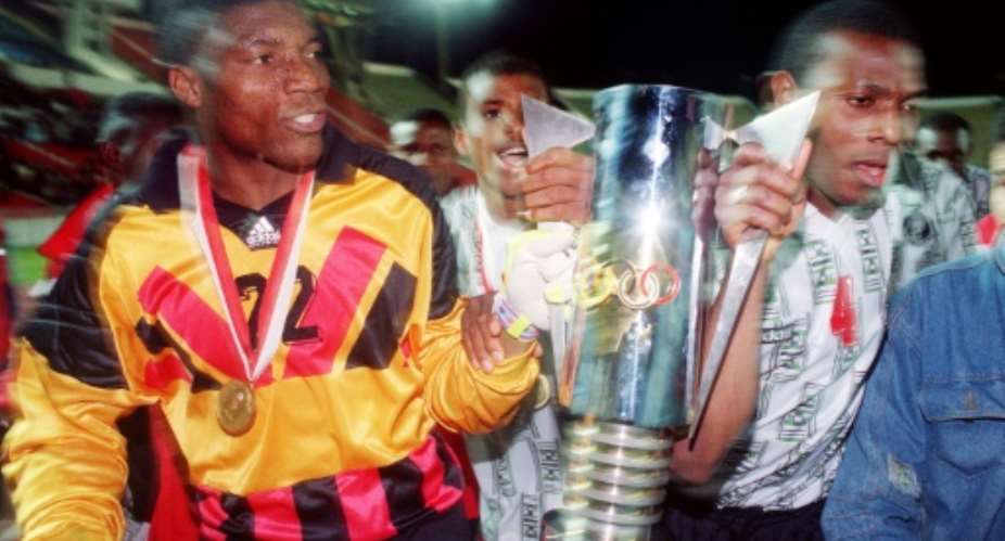 Nigerian goalie Peter Rufai (L) holds the African Nations Cup trophy won in 1994 against Zambia in Tunis.  By Fethi Belaid (AFP)