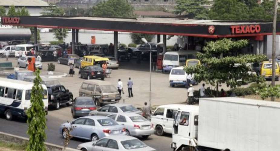 Motorists queue to buy fuel at a filling station in Lagos.  By Pius Utomi Ekpei AFPFile