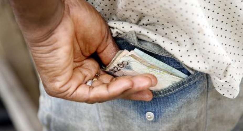 A man keeps his money in his back pocket in Lagos, April 15, 2008.  By Pius Utomi Ekpei AFPFile