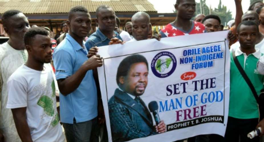 Supporters of popular Nigerian preacher TB Joshua, who counts powerful politicians from across Africa among his flock, is known to followers as The Prophet and The Man of God.  By Pius Utomi Ekpei AFPFile