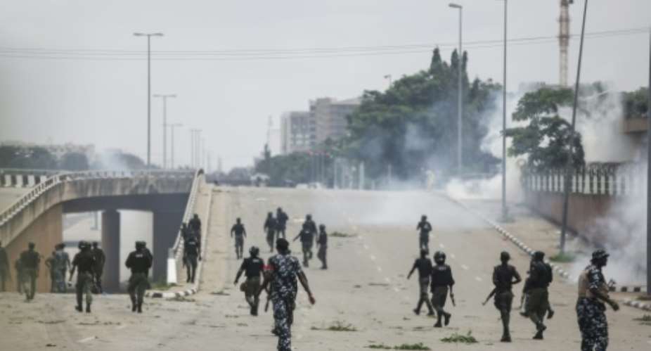 Nigerian security forces fire tear gas during the protests in Abuja.  By Kola Sulaimon (AFP)
