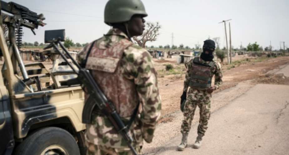 Nigerian soldiers, like these pictured in 2016, never received equipment to fight Boko Haram militants due to corruption in the defence procurement sector.  By STEFAN HEUNIS AFPFile