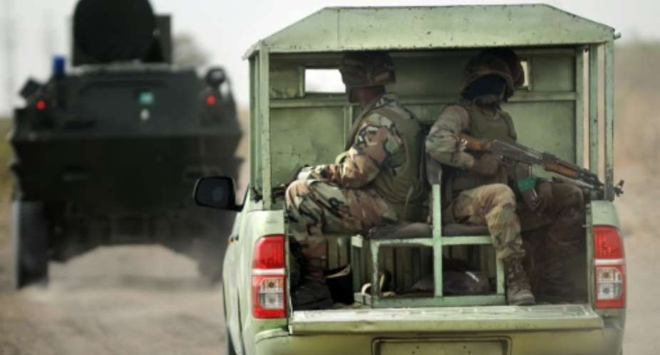 Nigerian soldiers patrol on June 5, 2013 near Maiduguri.  By Quentin Leboucher AFPFile