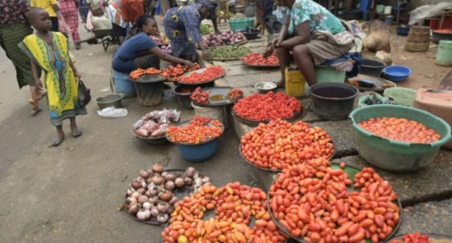 Vendors display tomatoes and pepper at Mile 12 market in Lagos, on June 21, 2016.  By Pius Utomi Ekpei AFP