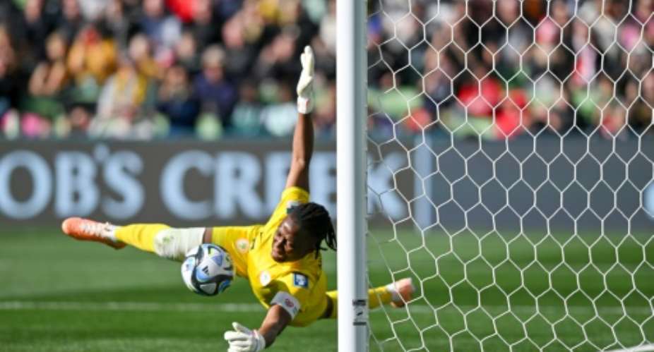 Nigerias goalkeeper Chiamaka Nnadozie saves a penalty kick by Canadas Christine Sinclair.  By Izhar KHAN (AFP)