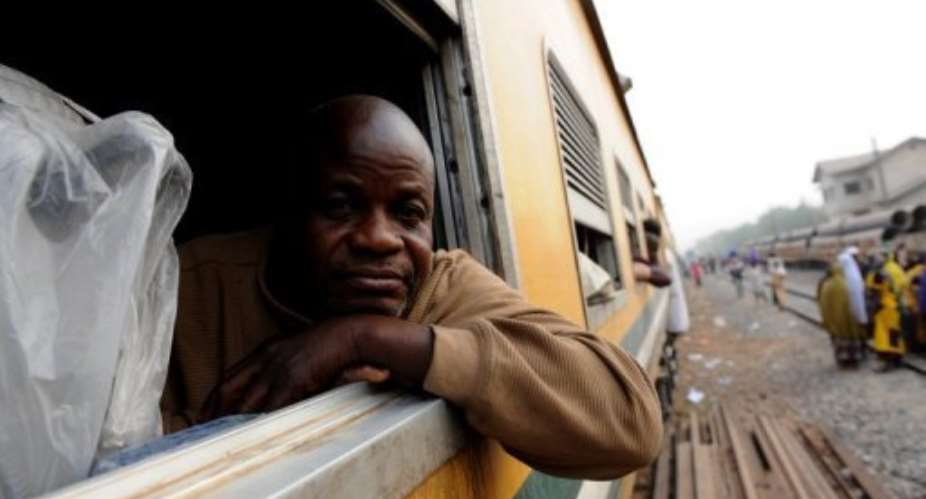A passenger relaxes in a carriage on the Kano to Lagos route train on February 8, 2013.  By Pius Utomi Ekpei AFP