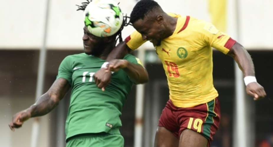 Nigeria's Victor Moses L heads the ball with Cameroon's Ngoran Fai during their match at Godswill Akpabio International Stadium in Uyo, southern Nigeria, on September 1.  By PIUS UTOMI EKPEI AFP