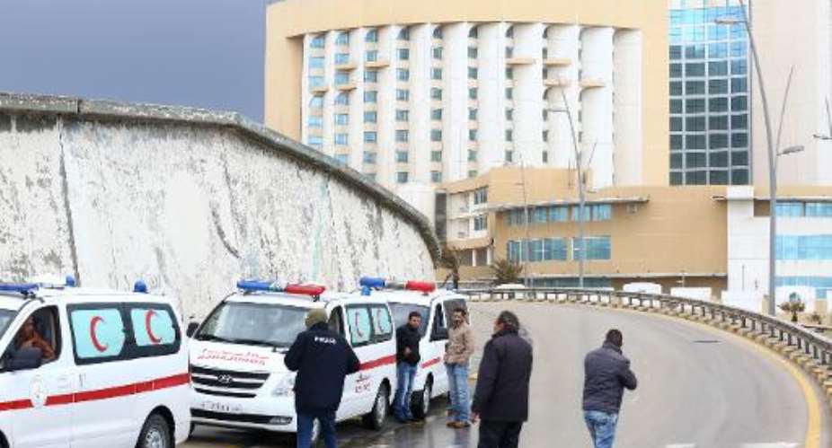 Libyan security forces and emergency services surround Tripoli's central Corinthia Hotel on January 27, 2015.  By Mahmud Turkia AFP