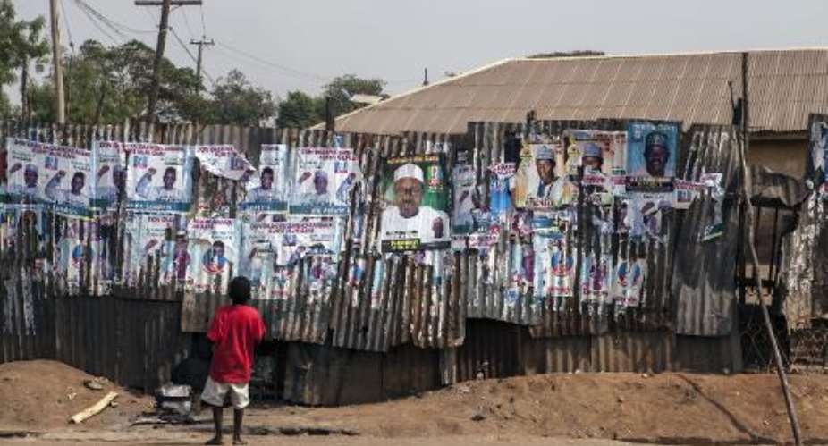 A boy looks at campaign posters on January 21, 2015 in Kaduna, Nigeria.  By Florian Plaucheur AFPFile