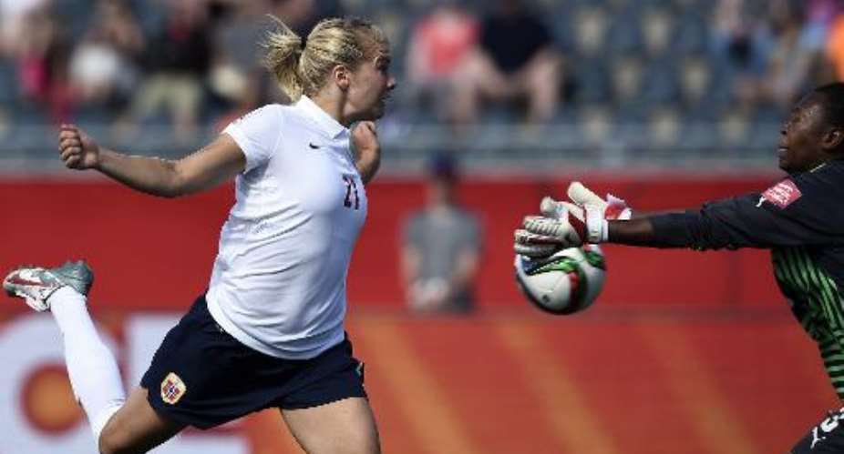 Norway's forward Ada Hegerberg challenges Ivory Coast's goalkeeper Cynthia Djohore during a Group B match at the 2015 FIFA Women's World Cup at Moncton Stadium, New Brunswick on June 15, 2015.  By Franck Fife AFP