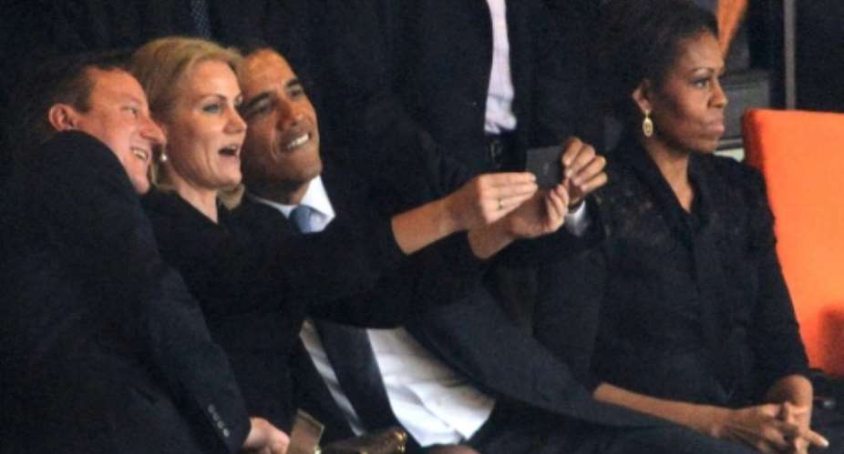 Obama and former prime ministers David Cameron of Britain and Denmark's Helle Thorning Schmidt pose for a selfie at Mandela's memorial service.  By ROBERTO SCHMIDT AFPFile