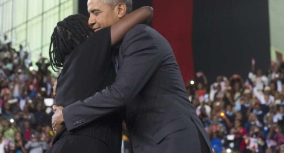 US President Barack Obama R embraces his half-sister Auma at the Moi International Sports centre in Nairobi on July 26, 2015.  By Saul Loeb AFP