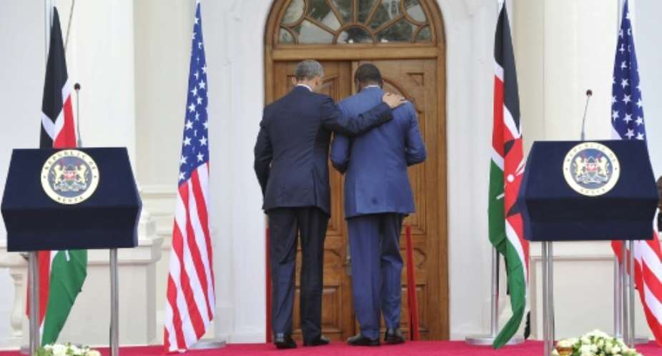 US President Barack Obama L and his Kenyan counterpart Uhuru Kenyatta leave after a press conference following their talks at the State House in Nairobi on July 25, 2015.  By Simon Maina AFP