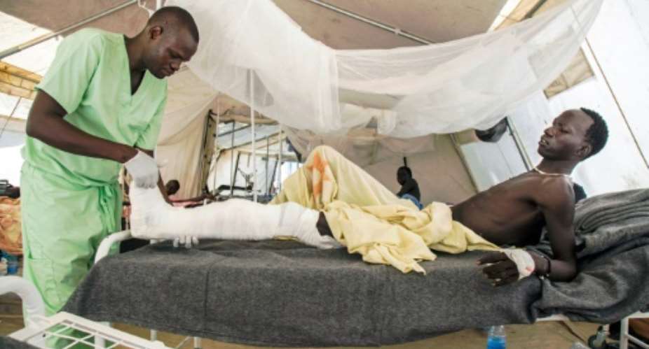 Old Fangak hospital in South Sudan has expanded from a single tent into several treatment rooms lined with white metal beds and warm blankets.  By ALBERT GONZALEZ FARRAN (AFP)