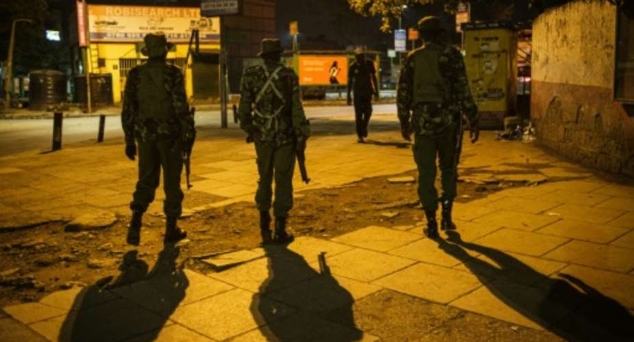 On patrol: Nairobi police during the curfew.  By Yasuyoshi CHIBA AFP