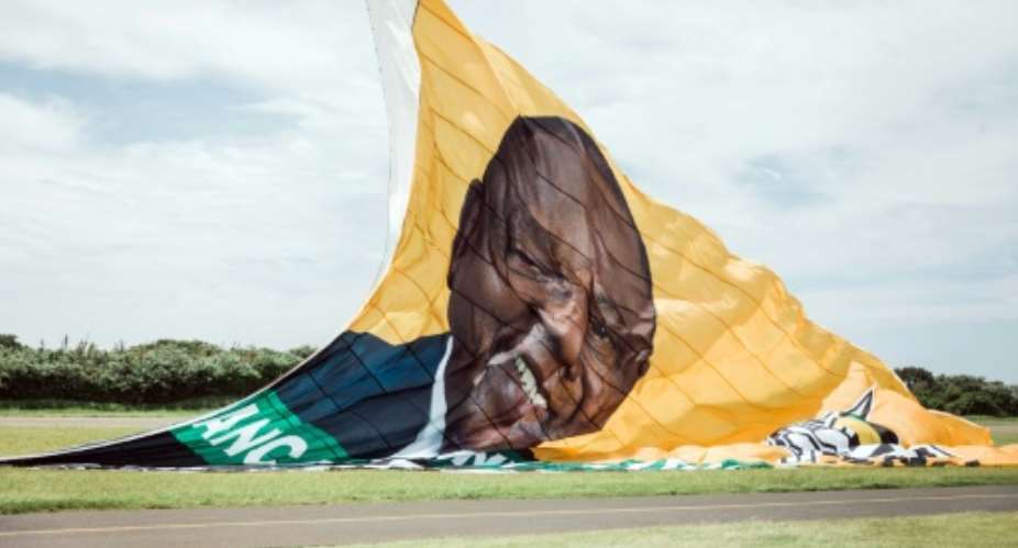 On the up: The ANC hoisted a giant New Year's banner bearing the face of Cyril Ramaphosa, credited with reviving party fortunes after the scandal-hit era of Jacob Zuma.  By RAJESH JANTILAL AFP