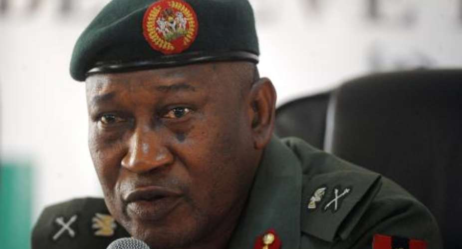 File picture shows defence spokesman Major-General Chris Olukolade speaks during a media briefing in Abuja on May 9, 2014.  By Pius Utomi Ekpei AFPFile