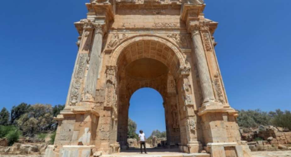 One of the few visitors to the ancient Roman city of Leptis Magna in Libya looks at the Arch of Septimius Severus.  By Mahmud TURKIA AFP