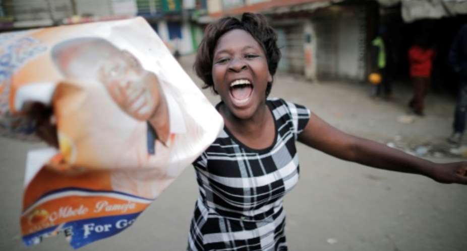 Opposition supporters streamed through Nairobi's Mathare slum on Thursday, shouting 'Uhuru must go'.  By MARCO LONGARI AFP