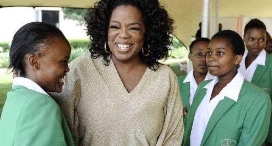 Oprah Winfrey with students of the first graduating class at her South African girls' academy in Henley on Klip.  By STEPHANE DE SAKUTIN AFP