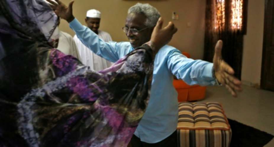 Osman Mirghani, who was released Friday, is greeted by his sister in the Sudanese city of Omdurman.  By ASHRAF SHAZLY AFP