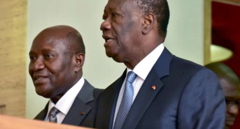 Outgoing Ivorian Prime Minister Daniel Kablan Duncan L walks with Ivorian president Alassane Ouattara R, following his resignation at the presidential palace in Abidjan, following his resignation on January 9, 2017.  By ISSOUF SANOGO AFP